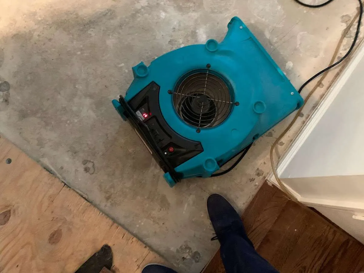 Air mover drying subfloor during Commercial Water Damage Restoration in Cortlandville